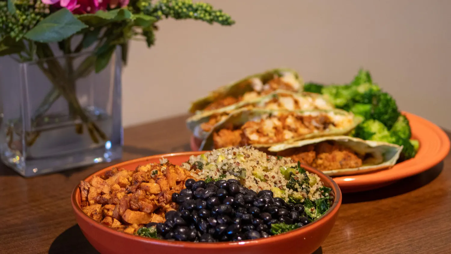 A harmony bowl and a buffalo cauliflower quesadilla dish sit on a table inside the Good Life Cafe on Jan. 29, 2024. The dishes are only two of the many healthy, vegan and non-vegan menu options offered by the restaurant.