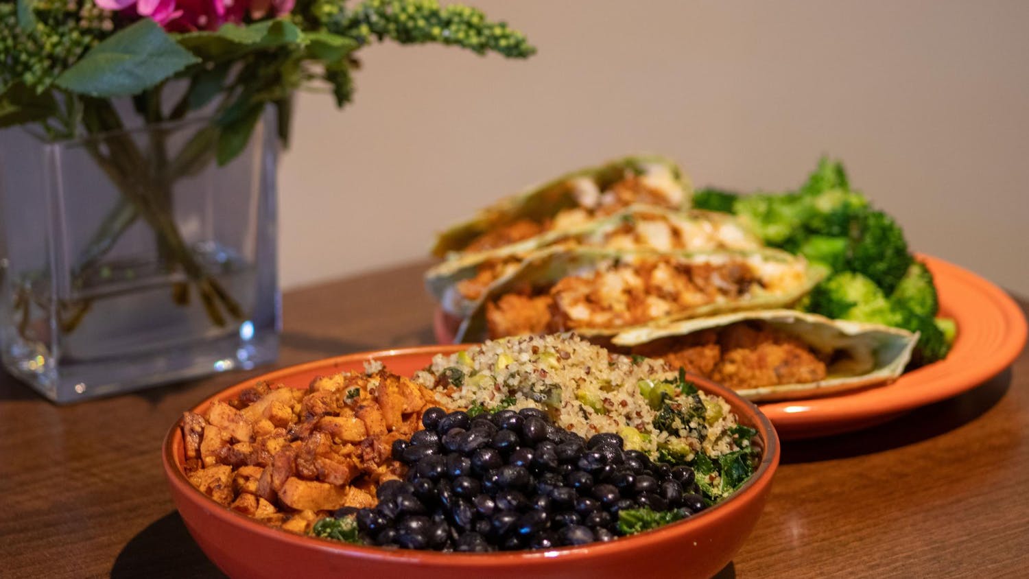 A harmony bowl and a buffalo cauliflower quesadilla dish sit on a table inside the Good Life Cafe&nbsp;on Jan. 29, 2024. The dishes are only two of the many healthy, vegan and non-vegan menu options offered by the restaurant.