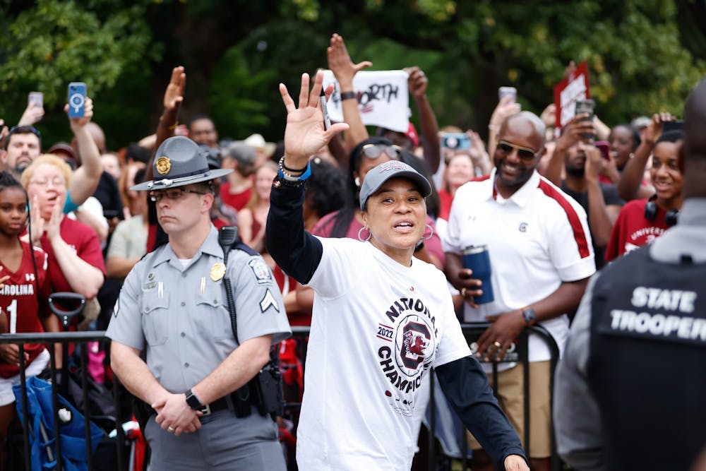 <p>FILE—Women's basketball coach Dawn Staley waves to fans after a parade on April 13, 2022, in honor of the team’s national championship win. The Gamecocks defeated UConn 64-49.&nbsp;</p>