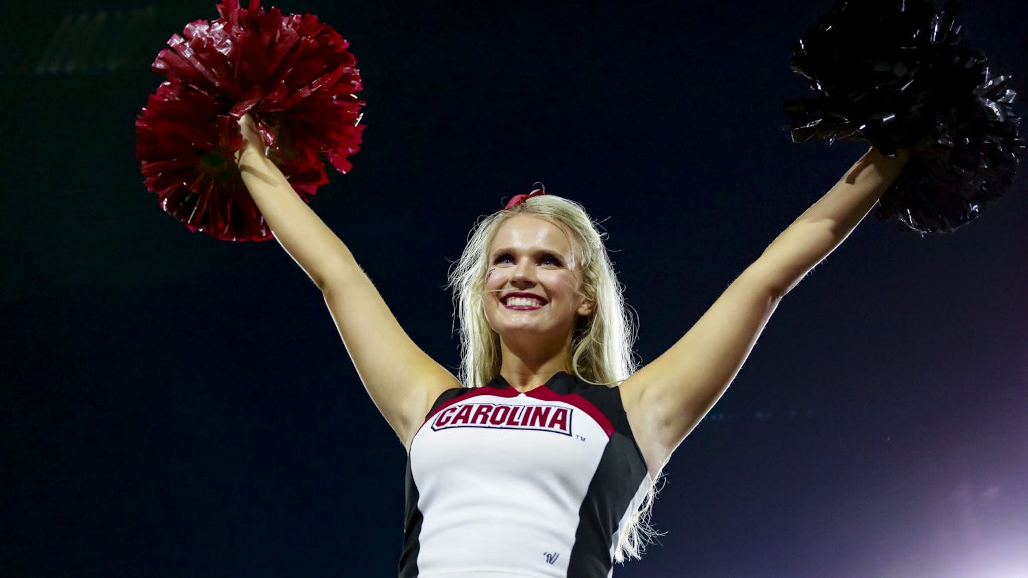 A Gamecock cheerleader performs a stunt during South Carolina's game against Georgia on September 18, 2021.