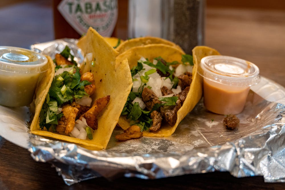 Three tacos sits in a paper try in Frida's Tacos Bar and Grill on Sept. 27, 2022. Frida's Tacos Bar and Grill and Madrigal Café are two of Columbia's newest restaurants located just outside of campus.