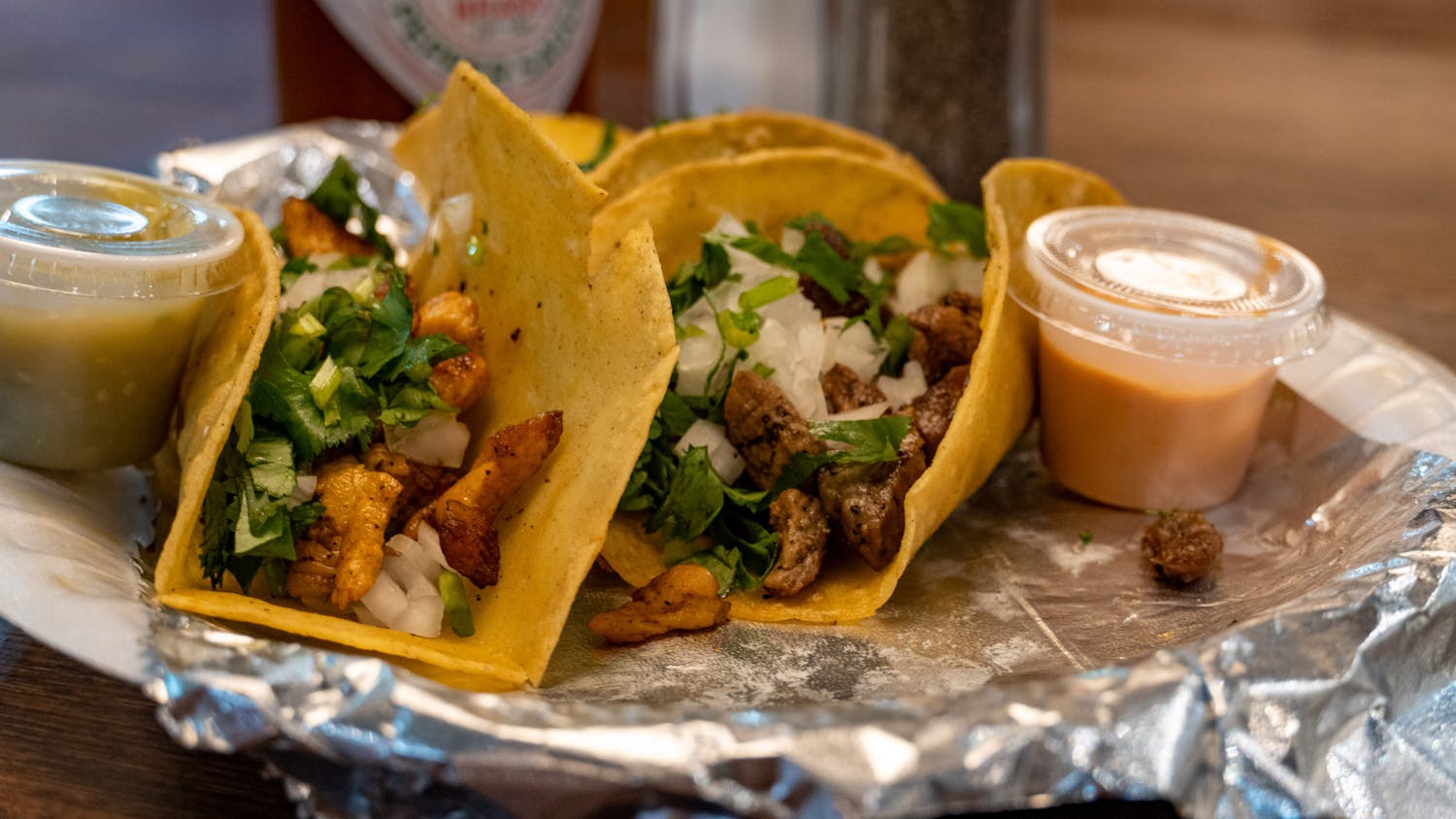 Three tacos sits in a paper try in Frida's Tacos Bar and Grill on Sept. 27, 2022. Frida's Tacos Bar and Grill and Madrigal Café are two of Columbia's newest restaurants located just outside of campus.