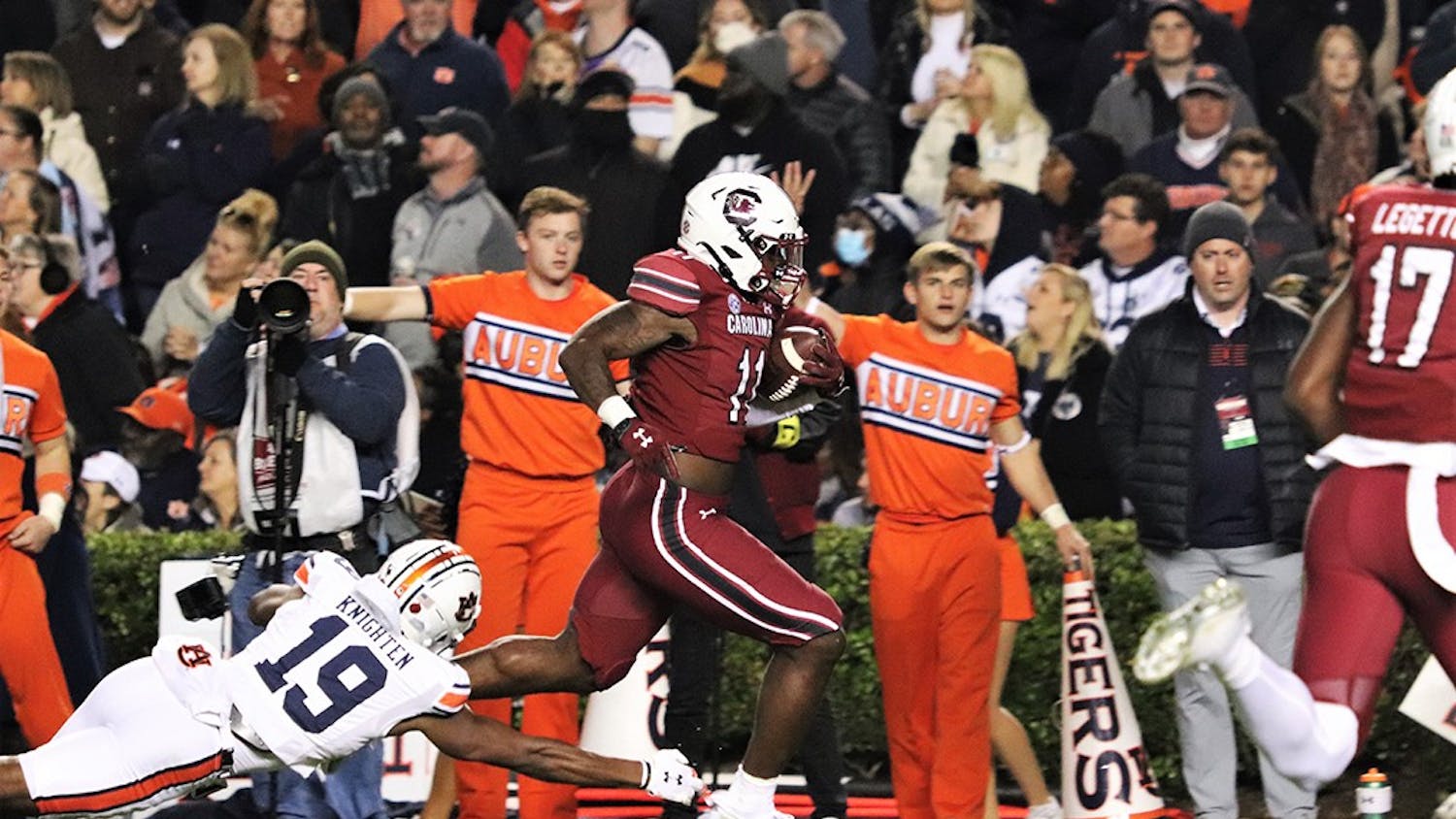 Redshirt senior ZaQuandre White runs out of the reach of Auburn safety Bydarrius Knighten (19) to score a touchdown. The Gamecocks defeated the Tigers 21-17 and are now bowl eligible for the first time since 2018.&nbsp;