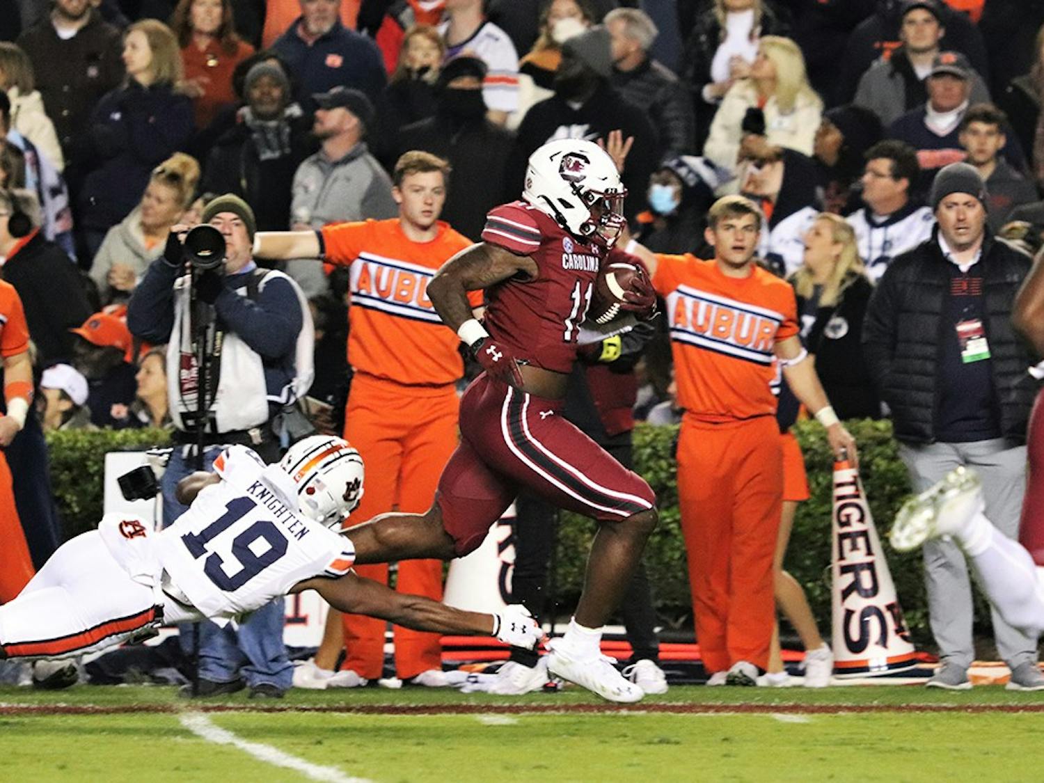 Redshirt senior ZaQuandre White runs out of the reach of Auburn safety Bydarrius Knighten (19) to score a touchdown. The Gamecocks defeated the Tigers 21-17 and are now bowl eligible for the first time since 2018.&nbsp;