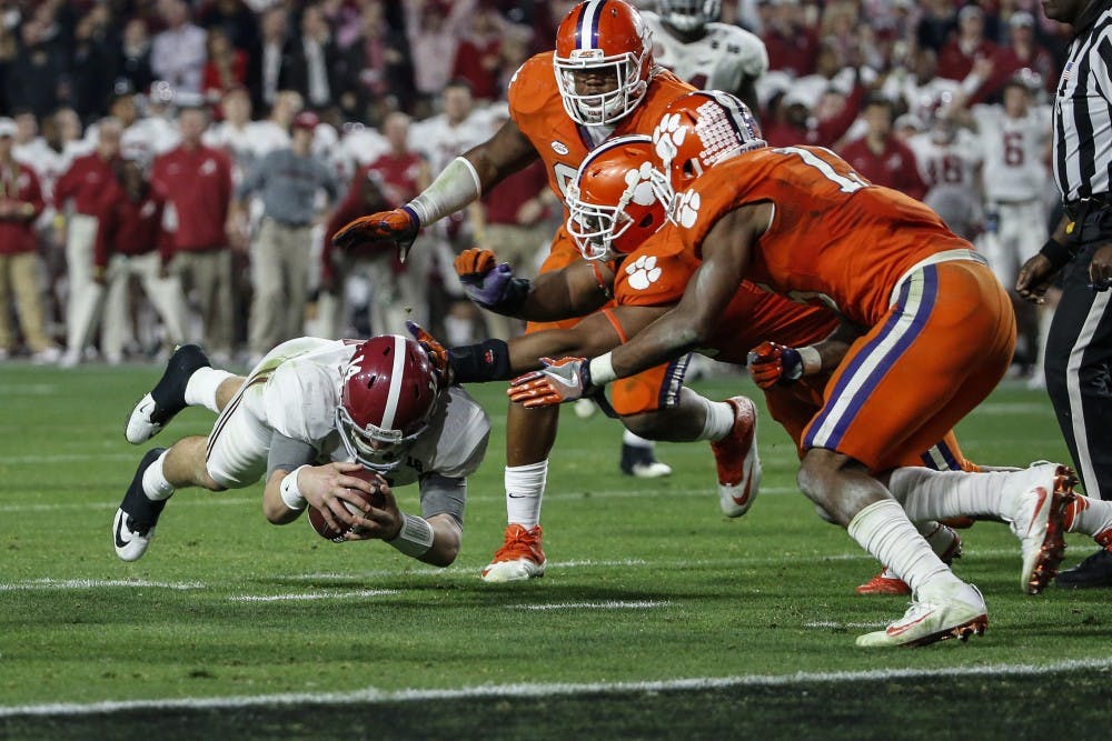 Alabama Crimson Tide quarterback Jake Coker (14) dives for a first down during the College Football Playoff National Championship game between the Alabama Crimson Tide and the Clemson Tigers at the University of Phoenix Stadium on Jan. 11, 2016 in Glendale, Ariz. Alabama won 45-40. (Tim Warner/CSM/Zuma Press/TNS) 