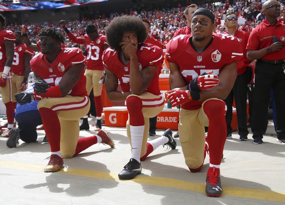 From left, San Francisco 49ers&apos; Eli Harold (58), quarterback Colin Kaepernick (7) and Eric Reid (35) kneel during the national anthem before their NFL game against the Dallas Cowboys on Sunday, Oct. 2, 2016 in Santa Clara, Calif. (Nhat V. Meyer/Bay Area News Group/TNS) 