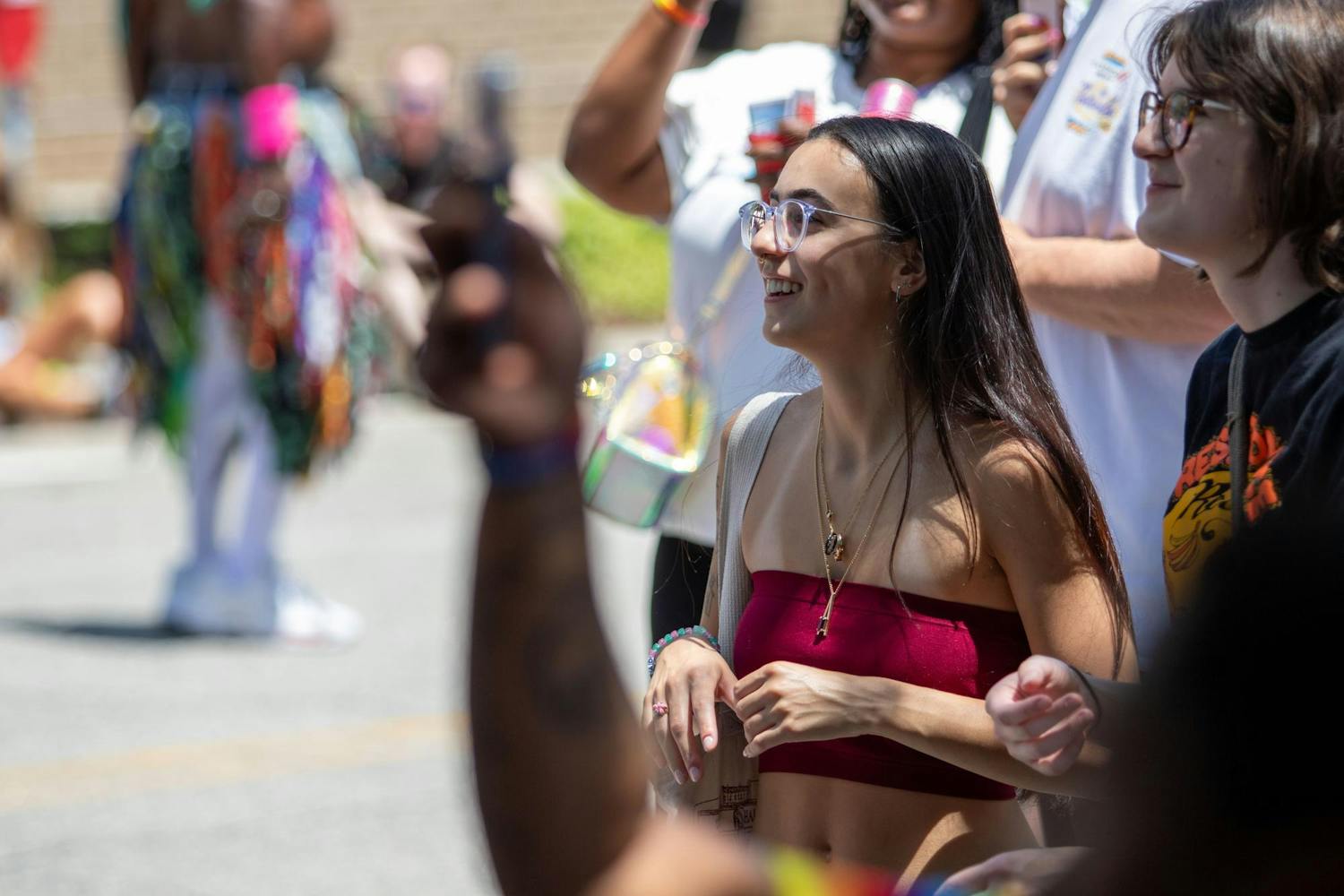 A spectator smiles while watching the drag competition during Outfest on June 1, 2024. Attendees had the chance to enjoy food, drinks, and watch the drag pageant throughout the day.