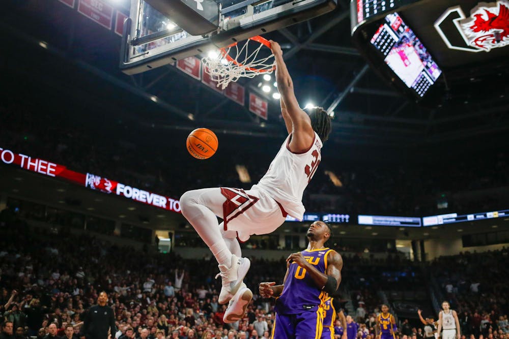 <p>FILE- Freshman forward Collin Murray-Boyles hangs on the rim of the basket during South Carolina’s game against LSU at Colonial Life Arena on Feb. 17, 2024. The Gamecocks defeated the Arkansas Razorback 80-66 in the SEC tournament on March 14, 2024, and Murray-Boyles led scoring with 24 points.</p>