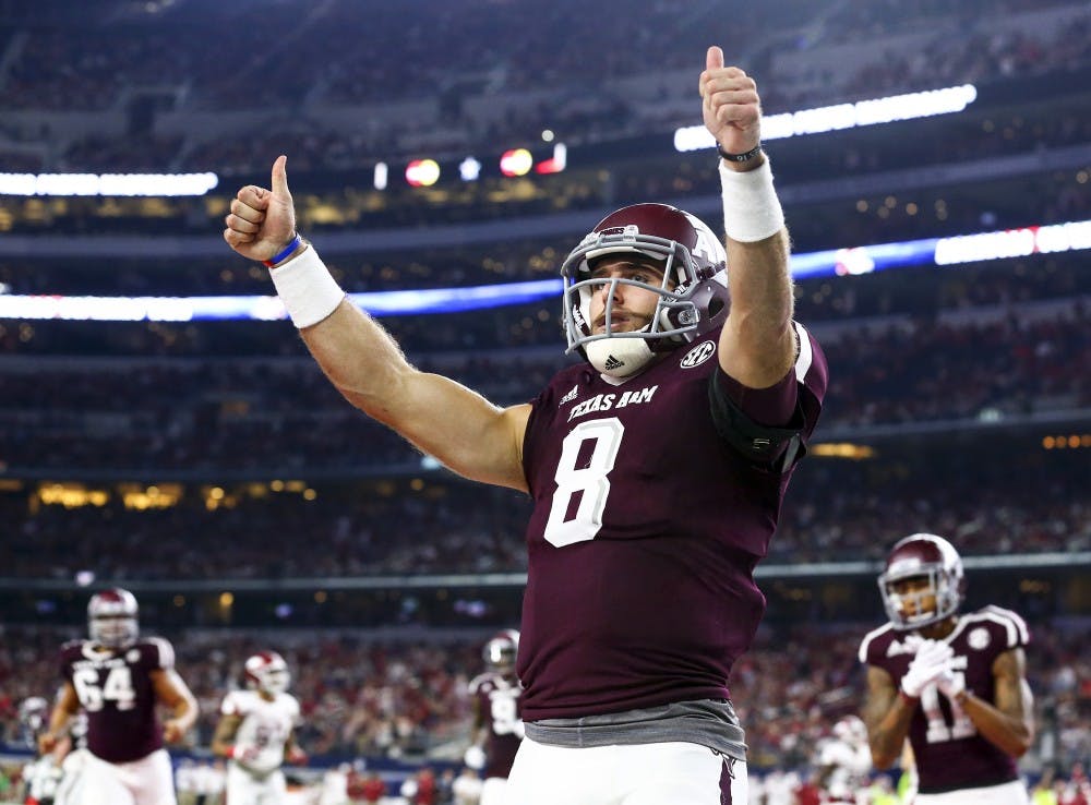 Texas A&M quarterback Trevor Knight (8) celebrates a touchdown against Arkansas in the second quarter at AT&T Stadium in Arlington, Texas, on Saturday, Sept. 24, 2016. (Richard W. Rodriguez/Fort Worth Star-Telegram/TNS)