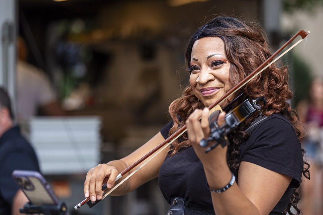Martina Williams plays the violin at Soda City Market on Sept. 23, 2023. Williams has played music professionally for two-and-a-half years and credits busking for helping her turn her passion for music into an occupation.