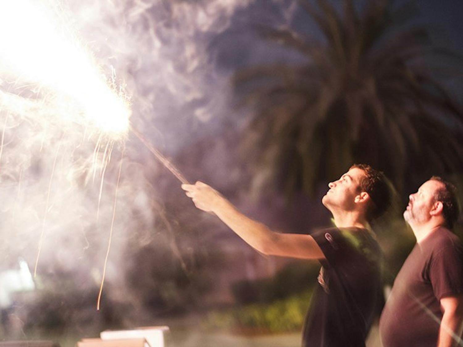 Shooting off roman candles, a type of firework, on New Year's Eve