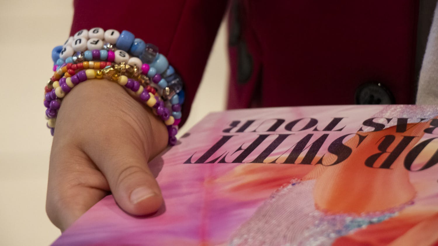 FILE — Channing Berry, 11, holds a free Taylor Swift poster during the opening night of Taylor Swift: The Eras Tour movie at AMC Harbison 14 on Oct. 13, 2023. Berry was sporting a "Red" era coat and multiple friendship bracelets.