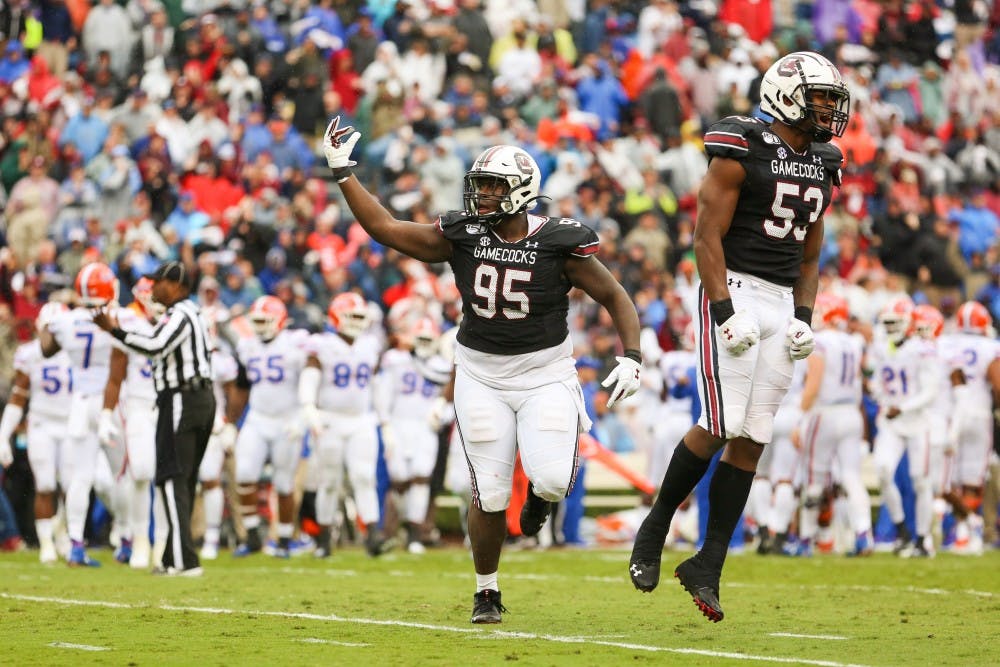 Senior defensive lineman Kobe Smith (left) and sophomore linebacker Ernest Jones (right) celebrate a touchdown during the game against Florida.
