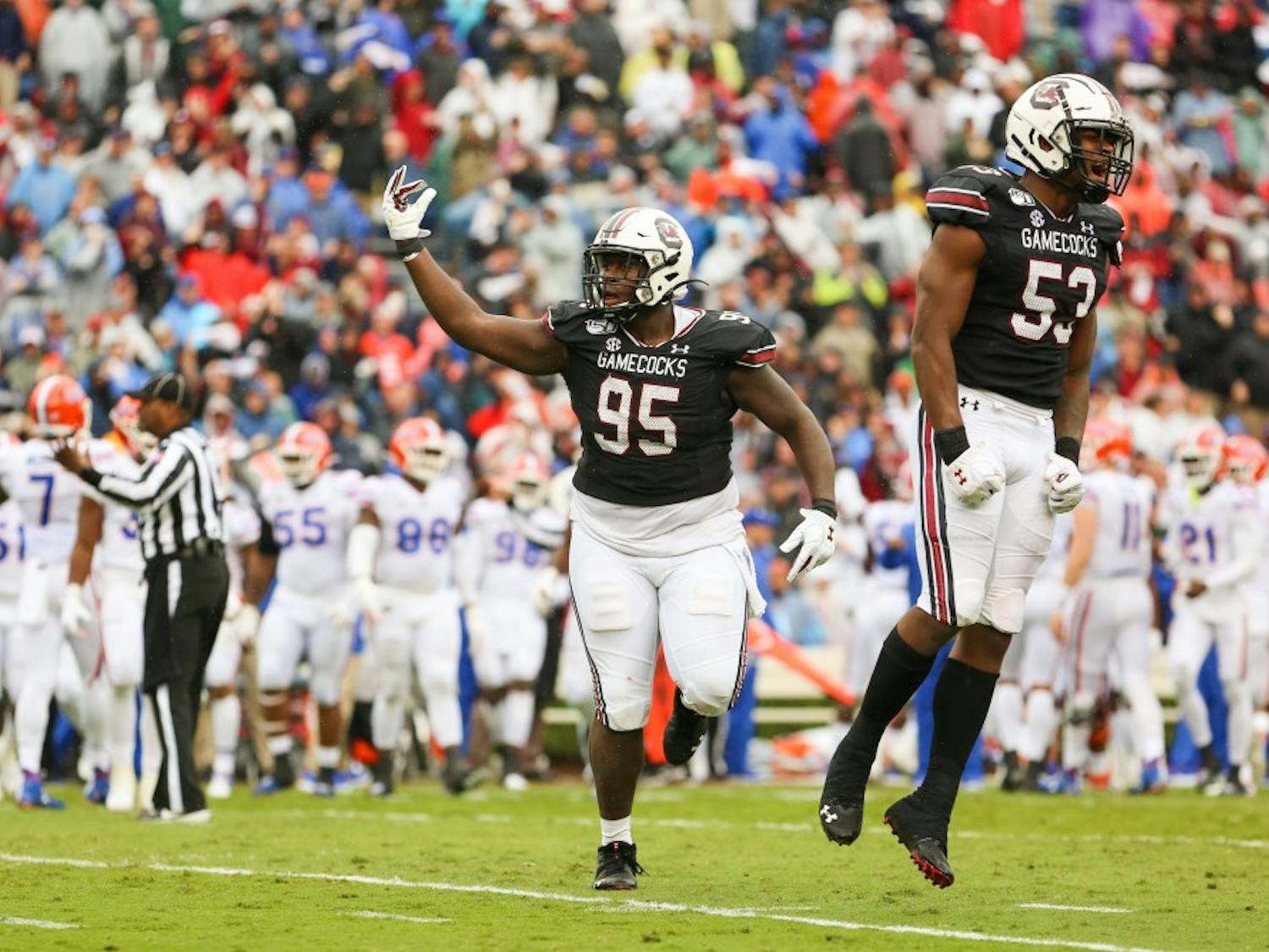 Senior defensive lineman Kobe Smith (left) and sophomore linebacker Ernest Jones (right) celebrate a touchdown during the game against Florida.