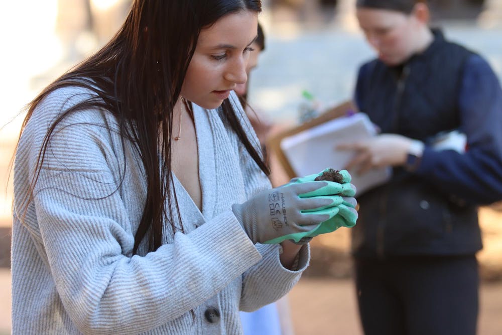 <p>Second-year student Samantha Addeo analyzes items found in the ground on the Horseshoe on Feb. 14, 2024. Some of the artifacts the students find will be on display in the McKissick Museum.</p>