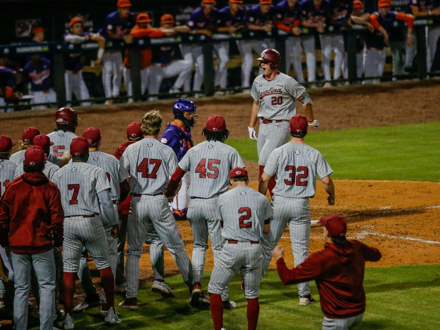 Members of the Gamecock baseball team celebrate as sophomore outfielder Ethan Petry crosses the plate after hitting a homerun during South Carolina’s game against Clemson at Segra Park on March 2, 2024. The “Battle at Bull Street” game ended with the Gamecocks losing 5-4 to the Tigers after 12 innings of play.