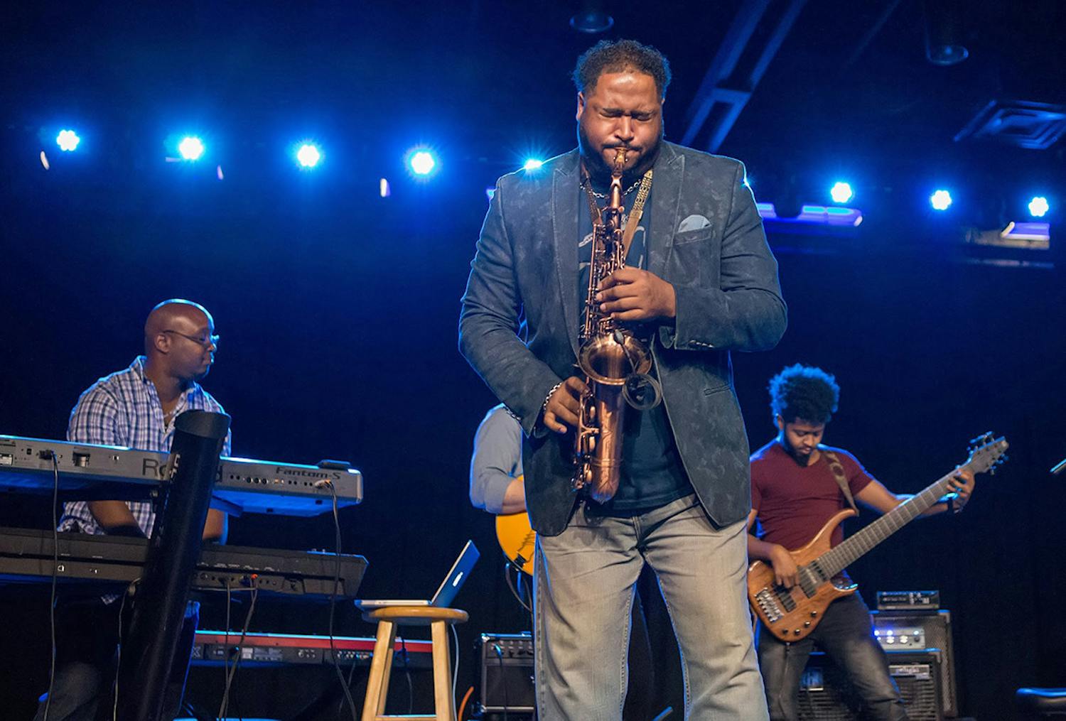 A saxophone player, keyboard player, and guitarist play their instruments to a jazz-loving crowd during a ColaJazz Fest performance. This year's festival is held on Sept. 24-25th, 2022, the ColaJazz Fest fall-edition is a weekend celebrating local and national jazz stars alike.