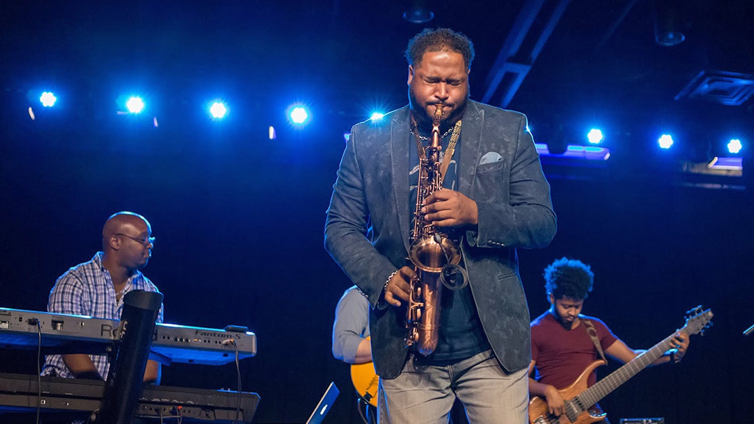 A saxophone player, keyboard player, and guitarist play their instruments to a jazz-loving crowd during a ColaJazz Fest performance. This year's festival is held on Sept. 24-25th, 2022, the ColaJazz Fest fall-edition is a weekend celebrating local and national jazz stars alike.