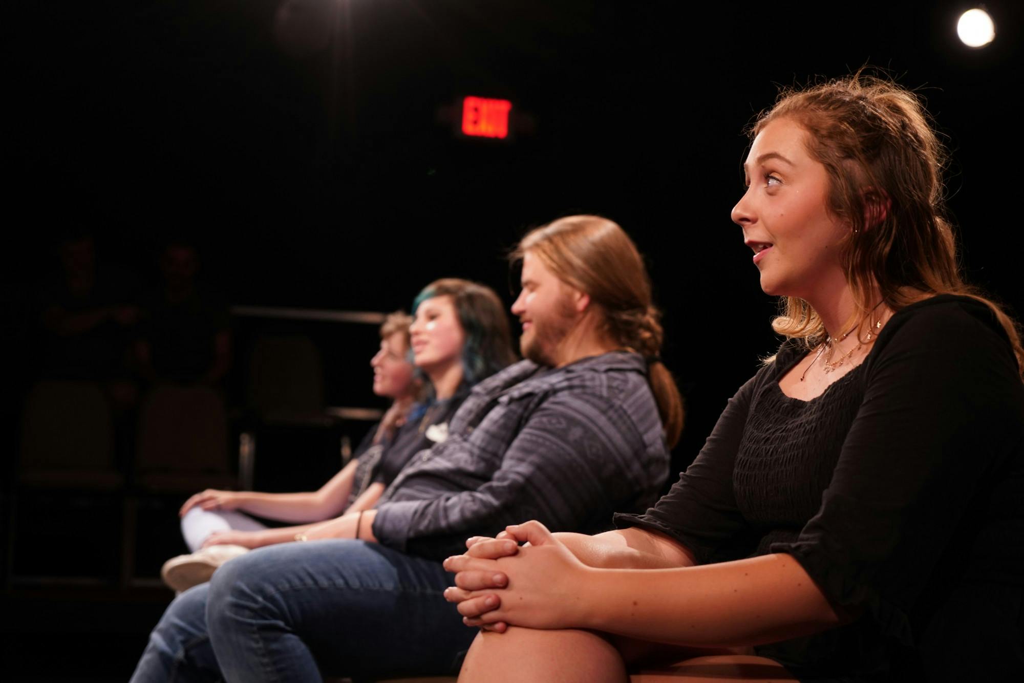 Amber Coulter sits in a row with Casey Downs, Susanna McElveen and Cassidy Spencer during the "Bon Voyage Prov" show in April 2019 by the OverReactors Improv club.