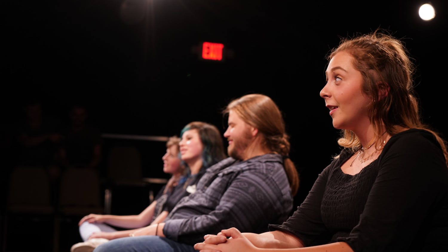 Amber Coulter sits in a row with Casey Downs, Susanna McElveen and Cassidy Spencer during the "Bon Voyage Prov" show in April 2019 by the OverReactors Improv club.