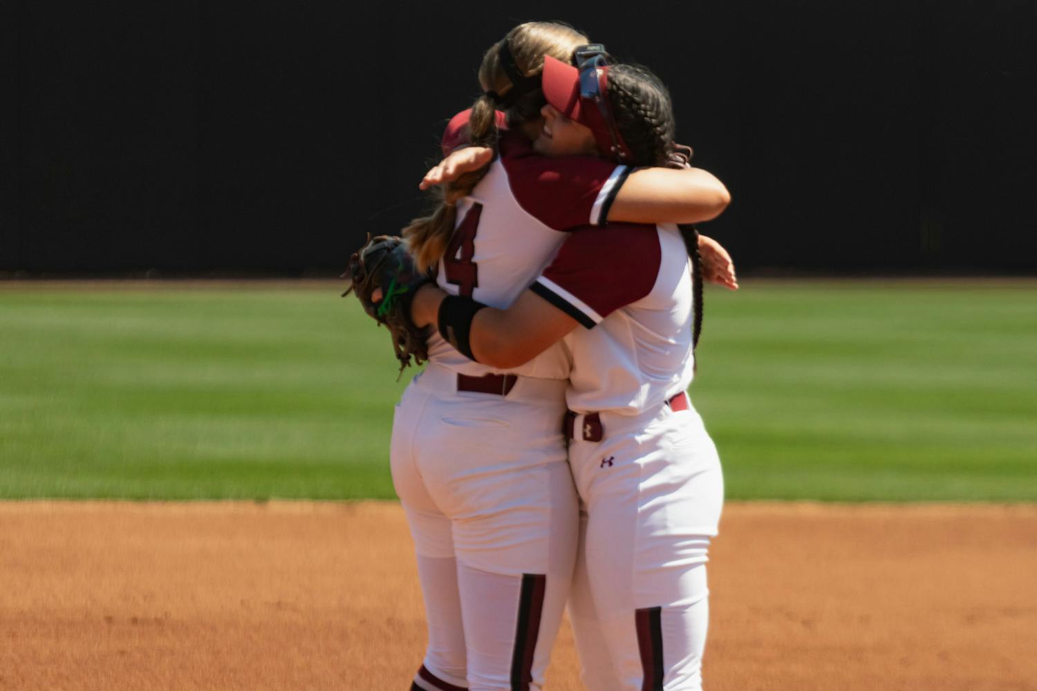 Sophomore infielder Emma Sellers and fifth-year catcher and infielder Jordan Fabian hug before the start of the first game against Charleston Southern at Beckham Field on April 19, 2023. The Gamecocks beat the Buccaneers 5-0 and went on to sweep the doubleheader with an 11-2 victory later in the day.&nbsp;