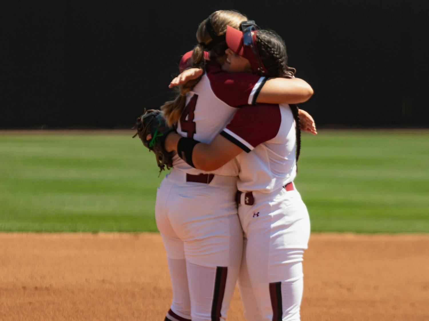 Sophomore infielder Emma Sellers and fifth-year catcher and infielder Jordan Fabian hug before the start of the first game against Charleston Southern at Beckham Field on April 19, 2023. The Gamecocks beat the Buccaneers 5-0 and went on to sweep the doubleheader with an 11-2 victory later in the day.&nbsp;