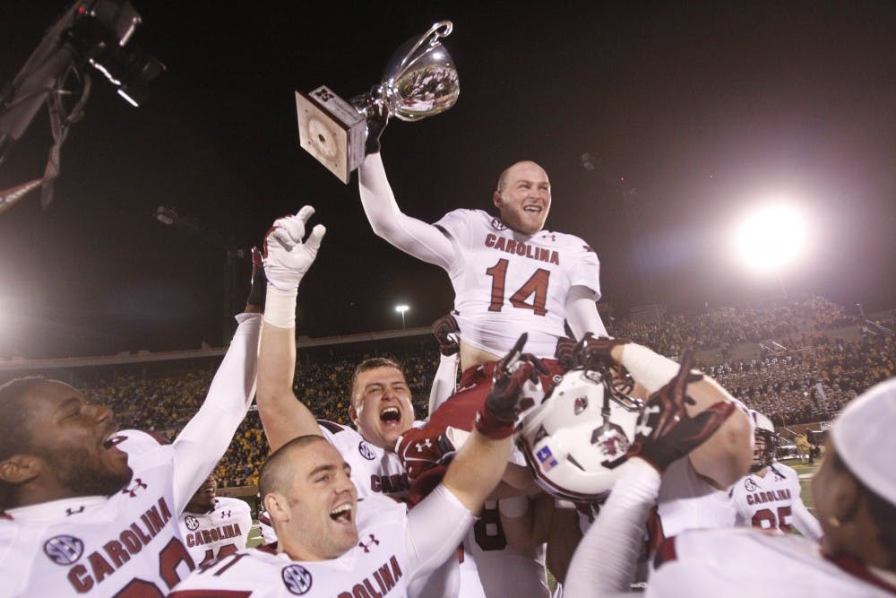 The South Carolina Gamecocks quarterback Connor Shaw (14) celebrates with teammates after defeating the Missouri Tigers, 27-24 in overtime at Memorial Stadium's Faurot Field in Columbia, Missouri, on Saturday, October 26, 2013. (Allison Long/Kansas City Star/MCT)