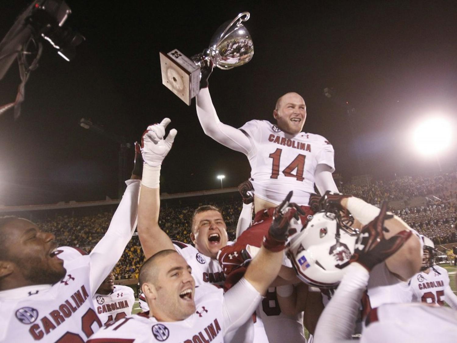 The South Carolina Gamecocks quarterback Connor Shaw (14) celebrates with teammates after defeating the Missouri Tigers, 27-24 in overtime at Memorial Stadium's Faurot Field in Columbia, Missouri, on Saturday, October 26, 2013. (Allison Long/Kansas City Star/MCT)