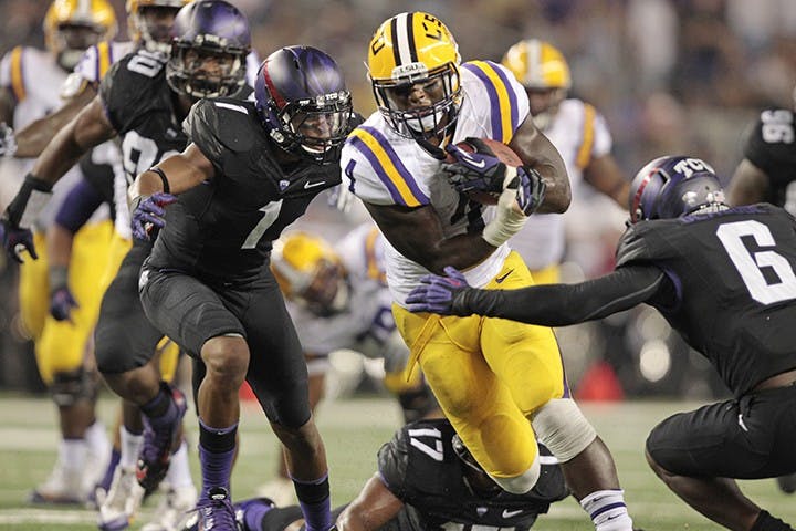 The Texas Christian defense pursues running back Alfred Blue (4) of Louisiana State at Cowboys Stadium in Arlington, Texas, on Saturday, August 31, 2013. (Ron T. Ennis/Fort Worth Star-Telegram/MCT)