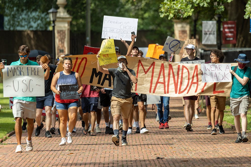 <p>The USC Turning Point USA chapter and the Carolina Socialists protest on the Horseshoe over the mask mandate. The mask mandate was put in place by interim university President Harris Pastides on Aug. 18, 2021.</p>