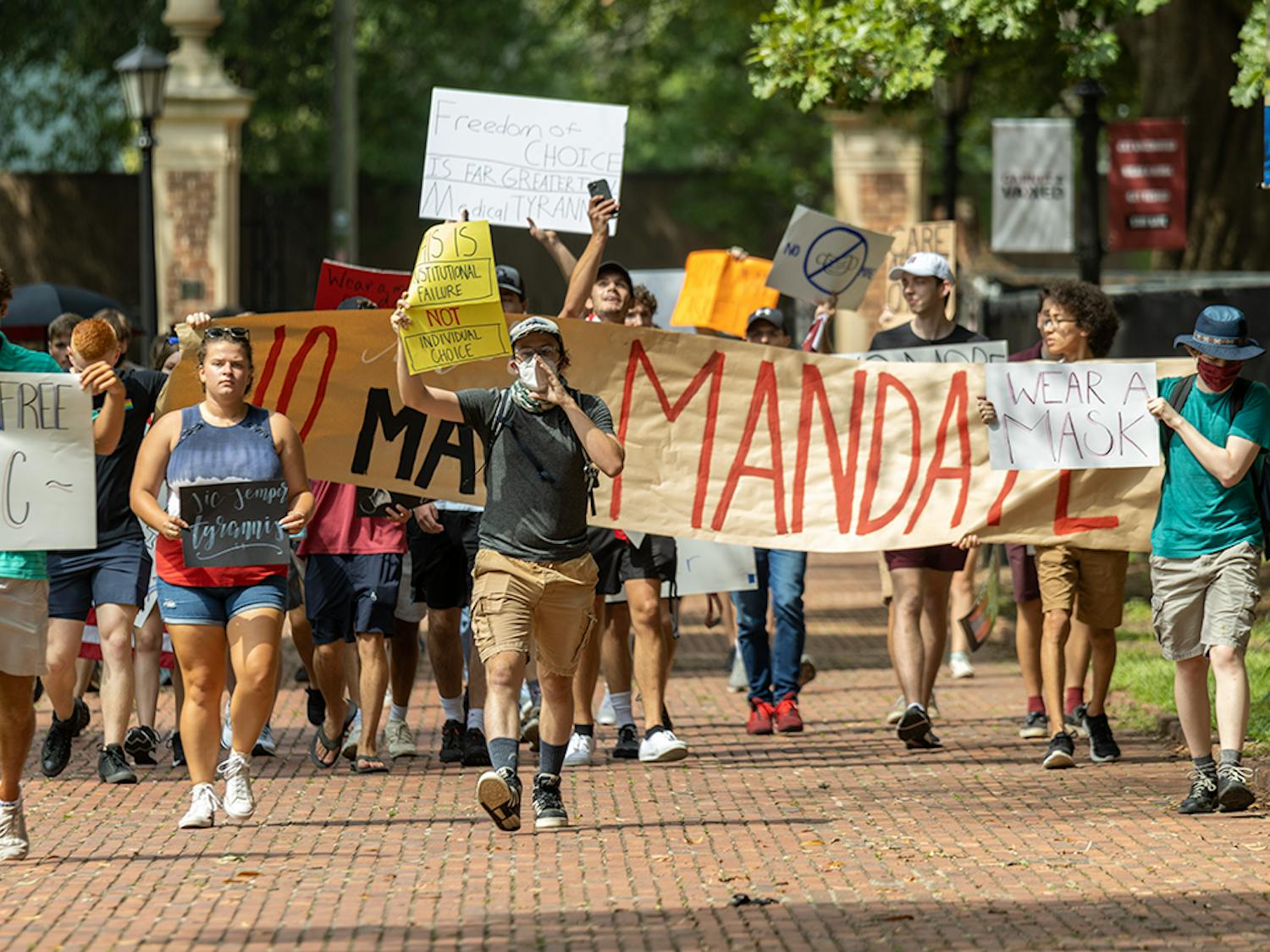 The USC Turning Point USA chapter and the Carolina Socialists protest on the Horseshoe over the mask mandate. The mask mandate was put in place by interim university President Harris Pastides on Aug. 18, 2021.