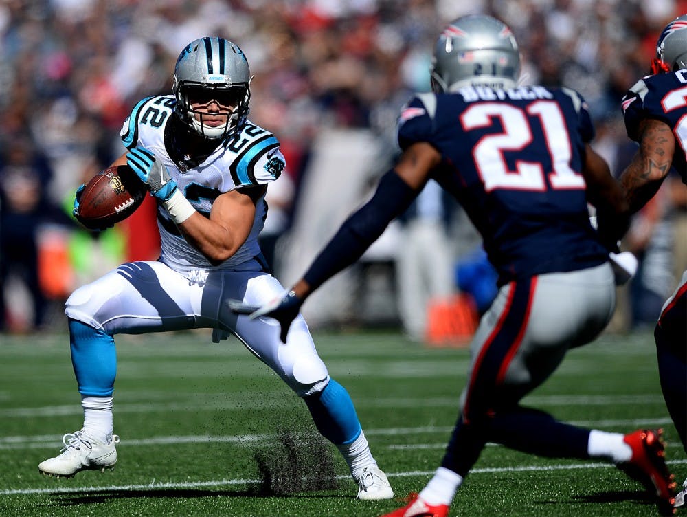Carolina Panthers running back Christian McCaffrey, left, looks to break to the outside during first quarter action against the New England Patriots on Sunday, Oct. 1, 2017 at Gillette Stadium in Foxboro, Mass. The Panthers defeated the Patriots 33-30. (Jeff Siner/Charlotte Observer/TNS)