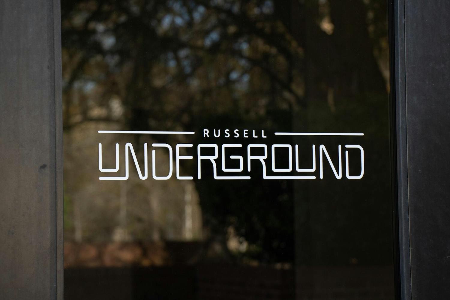 The doors to Russell Underground, a multipurpose venue for students, show a logo on March 11, 2024. The Music Industry Studies program started Live at the Underground to create a platform for local artists to perform on Wednesday nights.