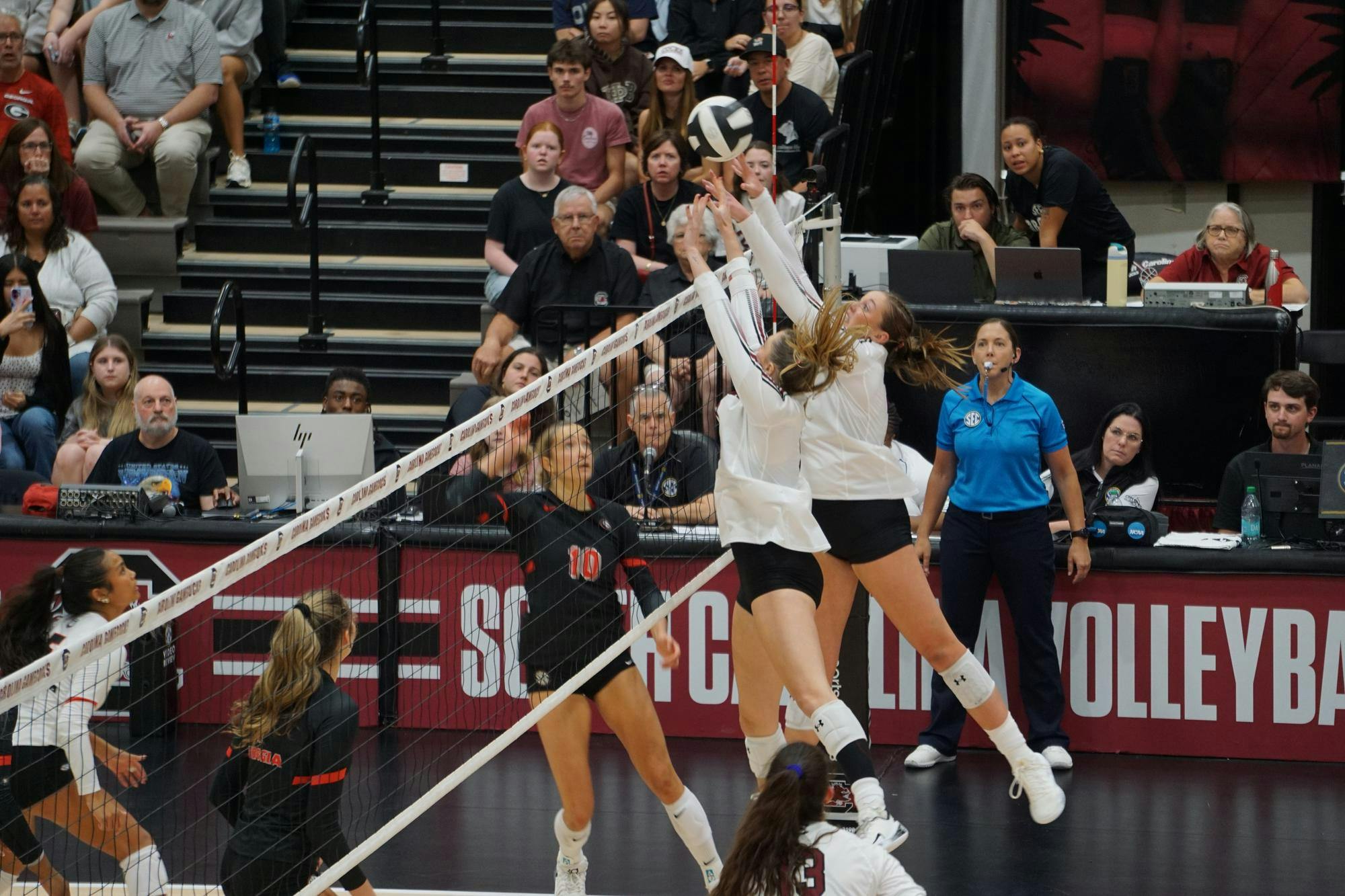 Junior middle Ava Leahy and senior setter Sarah Jordan jump to block the volleyball against Georgia at the Carolina Volleyball Center on Oct. 5, 2025. The Gamecocks lost against the Bulldogs 3-1.