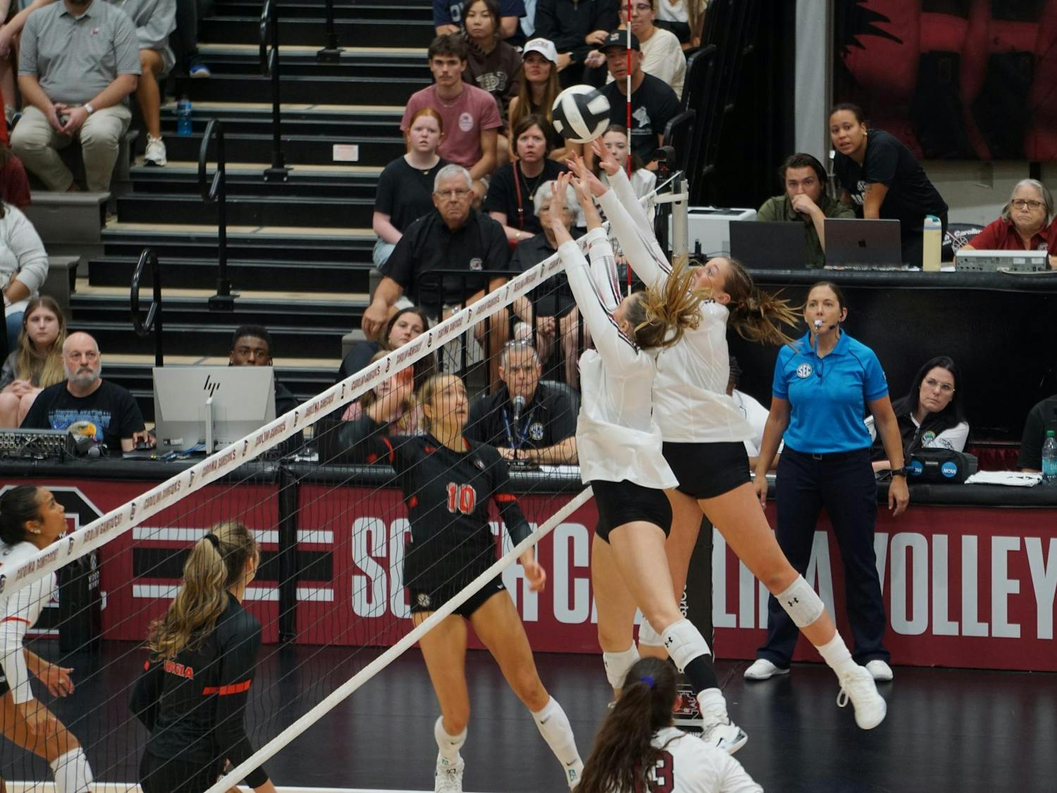 Junior middle Ava Leahy and senior setter Sarah Jordan jump to block the volleyball against Georgia at the Carolina Volleyball Center on Oct. 5, 2025. The Gamecocks lost against the Bulldogs 3-1.