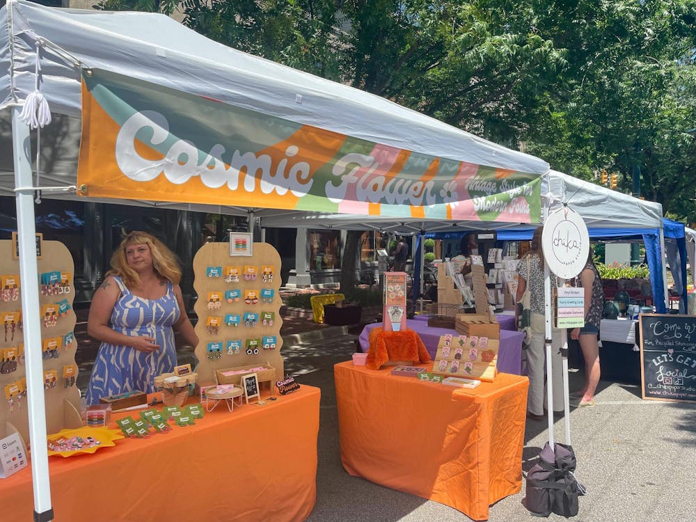 <p>Soda City Market vendor and owner/artist of Cosmic Flowers, Kimber Kirton, shares her creations with market-goers on July 6, 2024. Vintage-inspired handmade jewelry, pins, magnets and rings are sold at Cosmic Flowers. </p>