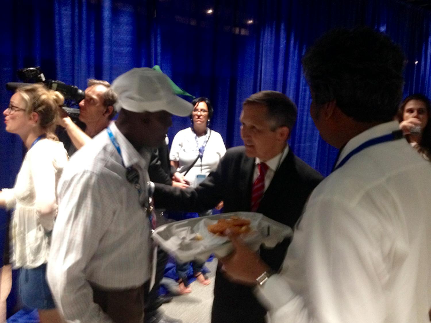 Two-time presidential candidate and former Ohio congressman Dennis Kucinich, center, chats with delegates on the first day of the Democratic National Convention in Philadelphia on July 25, 2016.
