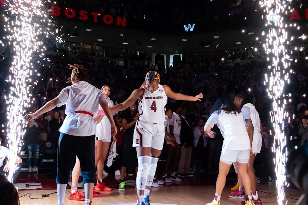 <p>FILE — Junior forward Aliyah Boston dances with graduate guard Lele Grissett as the starting lineup for the South Carolina Gamecocks is announced for the game on Sunday, Feb. 20, 2022 against the Tennessee Volunteers at Colonial Life Arena. Boston ended the season with 21 straight double-doubles.&nbsp;</p>