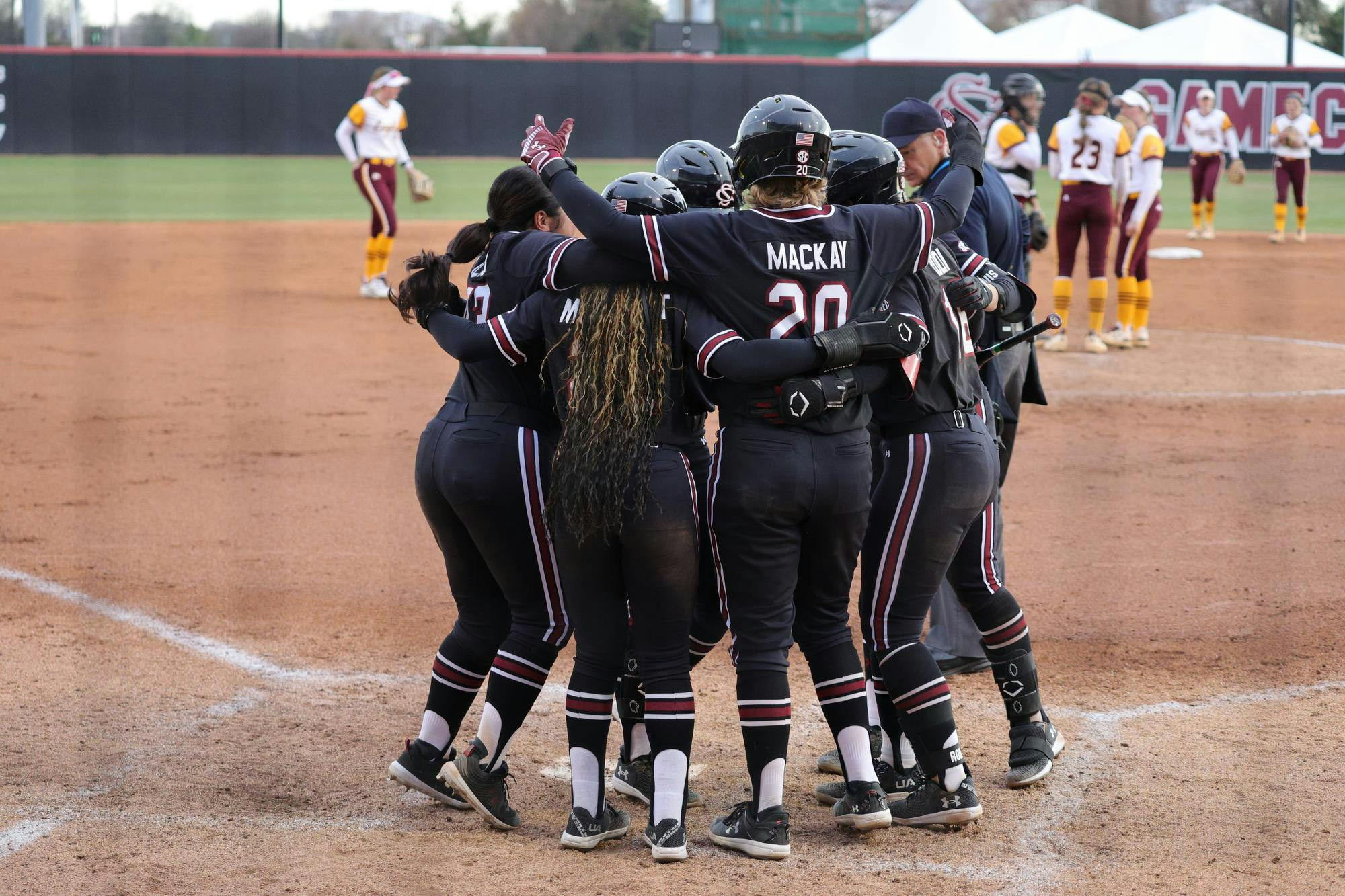 Junior infielder Karley Shelton celebrates with her teammates during South Carolina's game against Winthrop on Feb. 8, 2026, at Carolina Softball Stadium. The team gathers at home plate after a home run that brings in multiple runs.