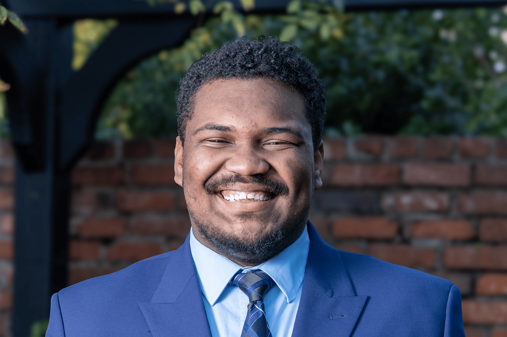Third-year criminology and criminal justice student Myron Harris poses for a portrait outside Kennedy Greenhouse Studio on Feb. 17, 2026. Harris will serve as student body vice-president for the 2026-27 school year.