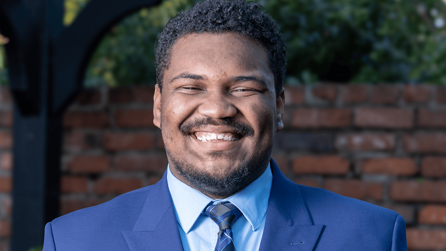 Third-year criminology and criminal justice student Myron Harris poses for a portrait outside Kennedy Greenhouse Studio on Feb. 17, 2026. Harris will serve as student body vice-president for the 2026-27 school year.