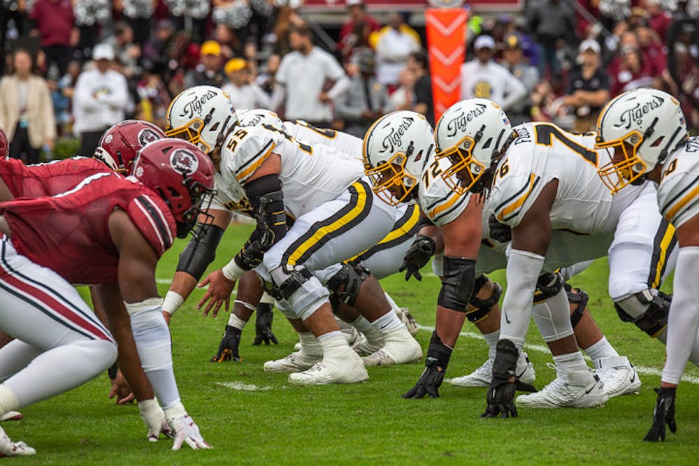 <p>The Missouri offensive line getting into position opposite of the South Carolina defensive line before a play on Oct. 29, 2022. Missouri held a strong defense against the Gamecocks, only allowing the latter to push 203 yards in the game, while Missouri made a total of 367 yards.</p>