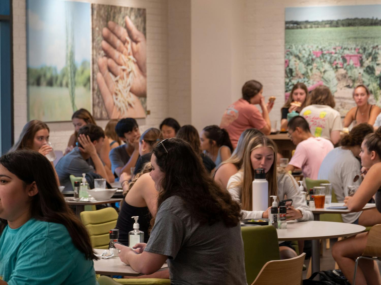 Students gather amongst tables in Fresh Greens on Sept. 20, 2022. Fresh Greene's, an organic buffet style eatery located in Russell House, serves fresh a fresh and healthier alternative to the campus community.