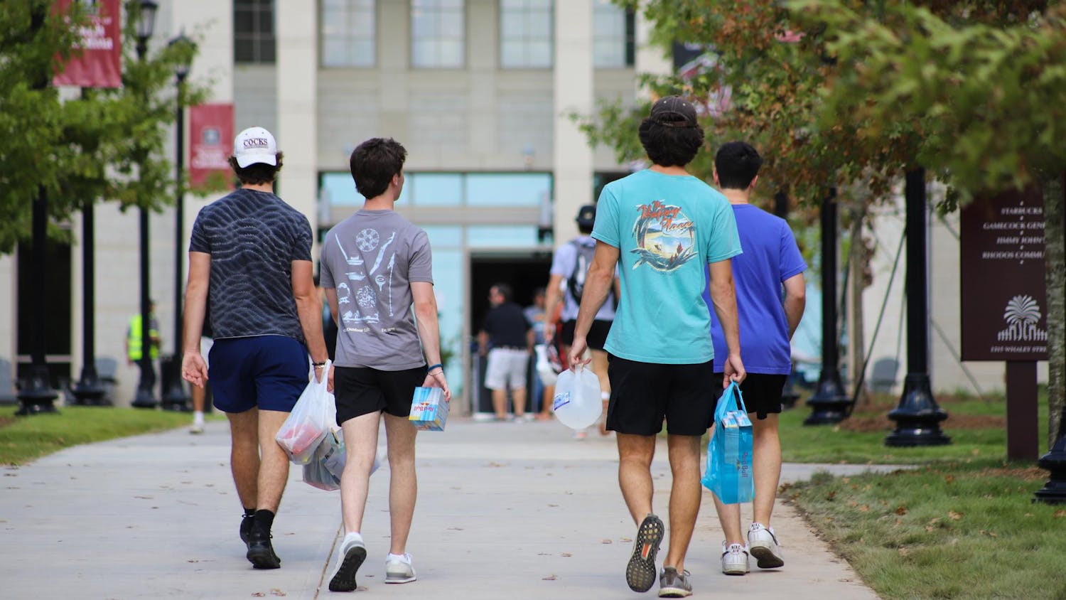 Freshman walking towards Campus Village as they start their journey at the University of South Carolina. Campus Village is made up of four modern buildings housing 1,800 total students, as well as commercial, retail and educational amenities.