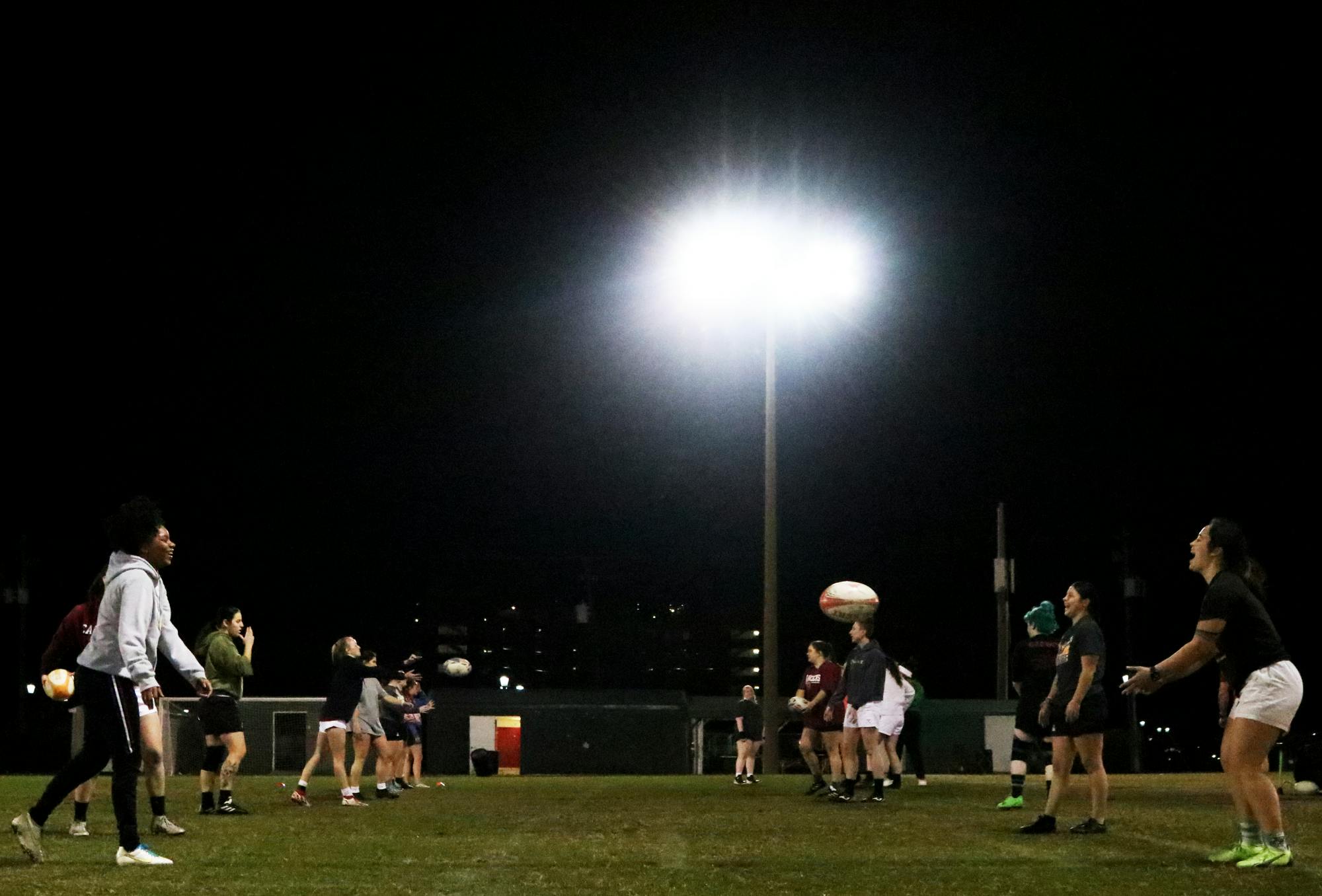 The Gamecocks women’s rugby team stretches and warms up for its Tuesday night practice at the Bluff Road Park practice fields on Feb. 7, 2023. The team has been preparing for its upcoming 2023 spring season since October 2022.