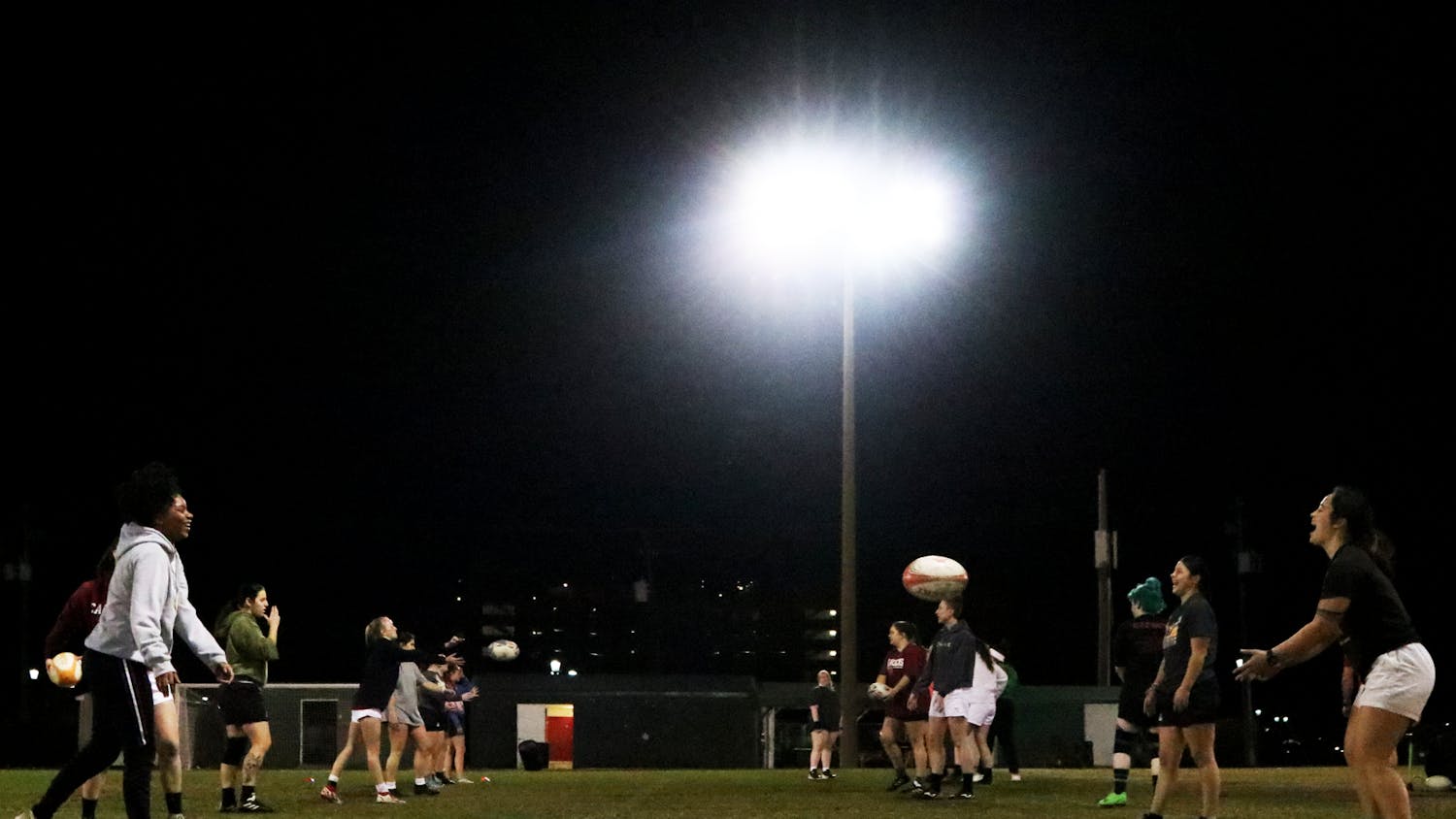 The Gamecocks women’s rugby team stretches and warms up for its Tuesday night practice at the Bluff Road Park practice fields on Feb. 7, 2023. The team has been preparing for its upcoming 2023 spring season since October 2022.