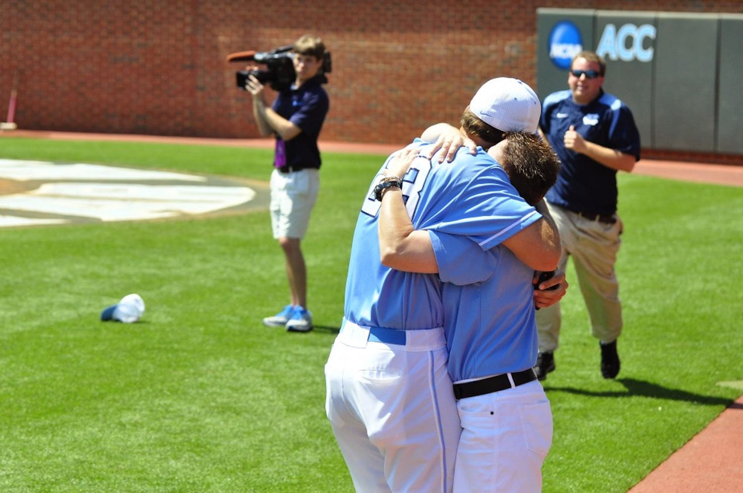 Bryant Gaines, assistant coach for the Tar Heels, embraces a staff member after the game.