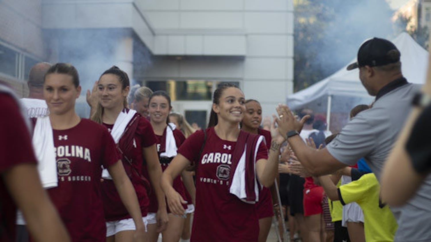 Junior defender Taylor Jacobson and her teammates on the women’s soccer team high-five surrounding families at a tailgate on Sept. 24, 2023. Families tailgate at the Roost Athletics Village prior to the team’s games.