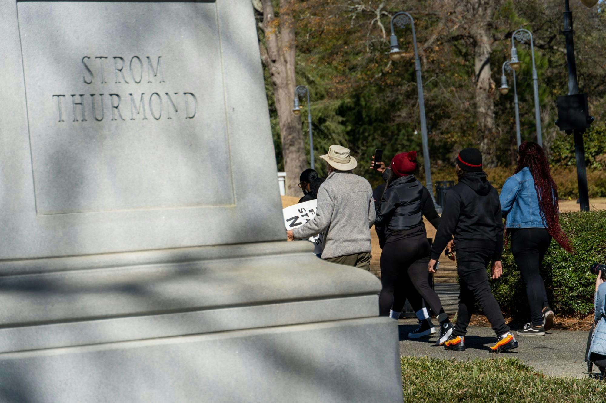 Upon arriving at the statehouse, protesters pass a monument dedicated to former SC governor Strom Thurmond on Feb. 5, 2022. Thurmond was an advocate for segregationist policies during his tenure as senator and used a filibuster in an attempt to stop a Civil Rights proposal in 1957.