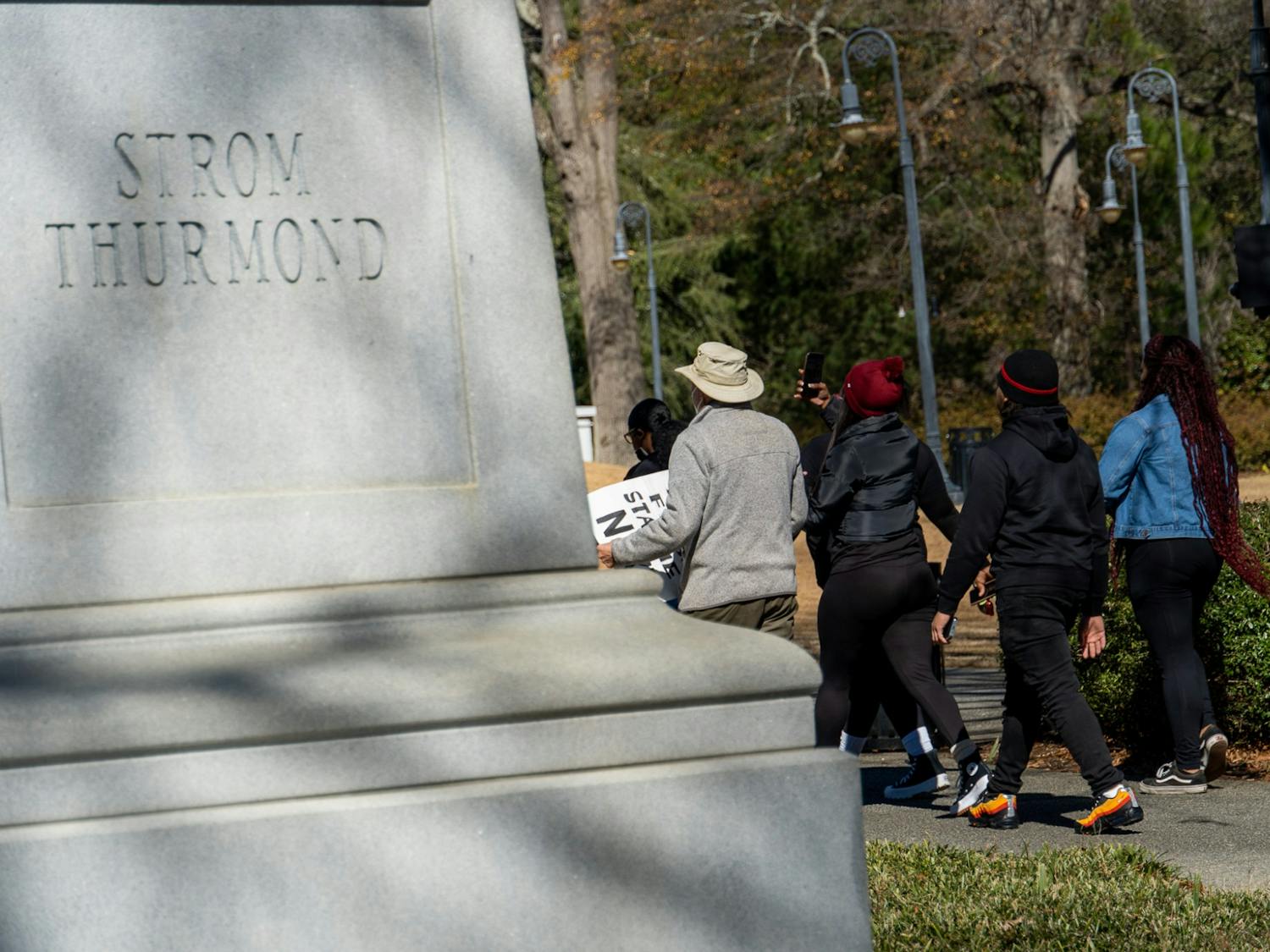 Upon arriving at the statehouse, protesters pass a monument dedicated to former SC governor Strom Thurmond on Feb. 5, 2022. Thurmond was an advocate for segregationist policies during his tenure as senator and used a filibuster in an attempt to stop a Civil Rights proposal in 1957.